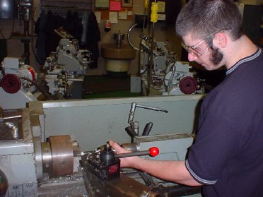 King o' sideburns workin' at the lathe